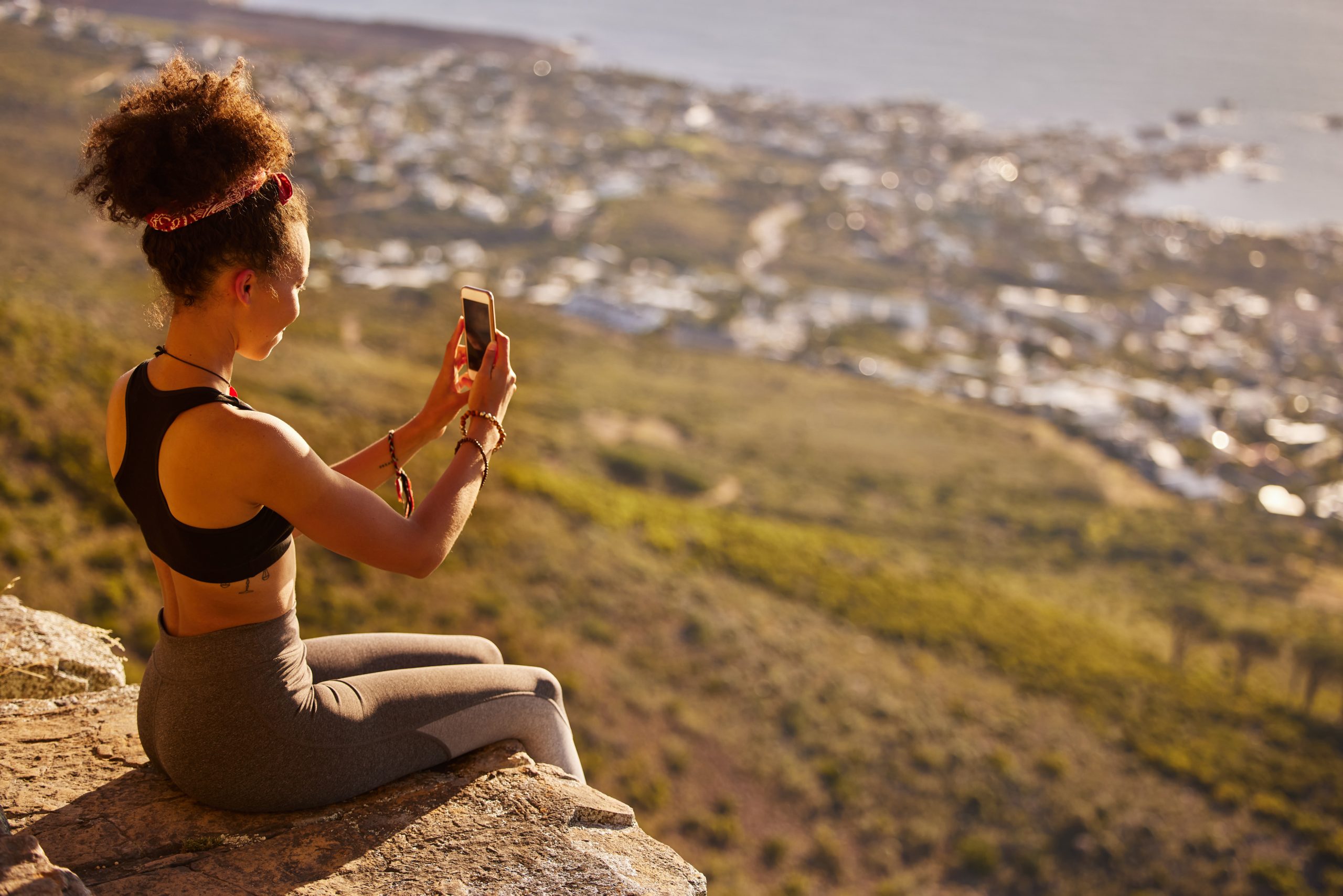 Traveller capturing a scenic view from a mountain